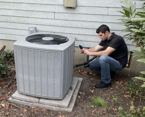 marc tucci inspecting an HVAC unit